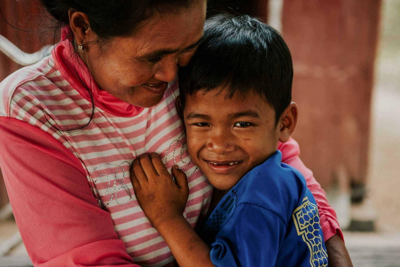 A young boy hugs his Children in Families foster mum