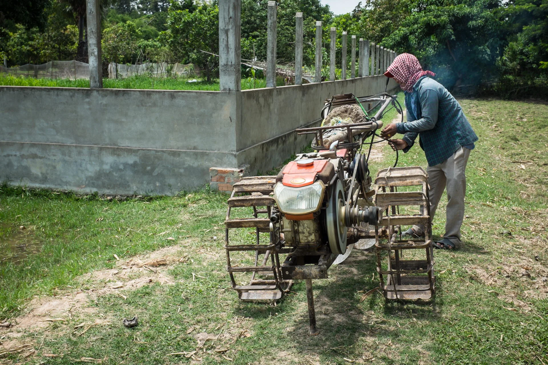 A local farmer prepares his gou-yun (robot cow) for a day's work.